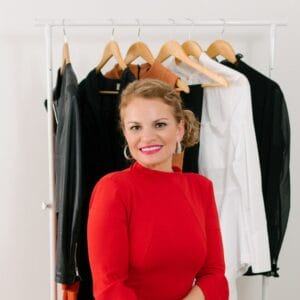 Personal Stylist Posing in Front of a Clothing Rack.