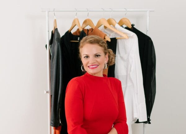 Personal Stylist Posing in Front of a Clothing Rack.